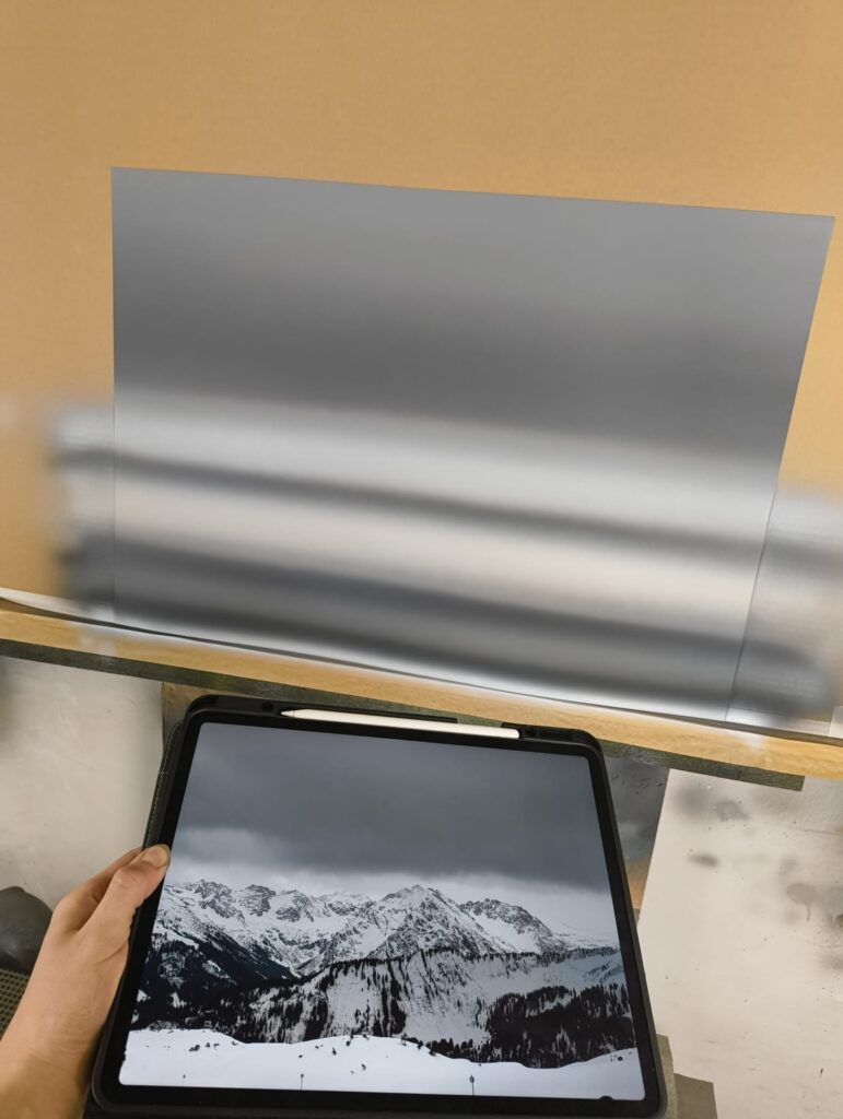 In the studio: Storm over Widderstein being airbrushed on art board, with the source photograph on a tablet