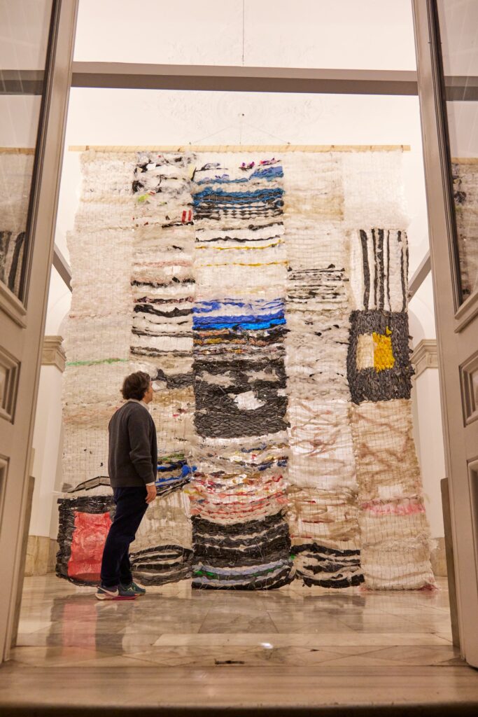 Making Something out of Nothing, Austrian Cultural Forum Istanbul (Palais Yeniköy), 2024. Woven plastic carpet with visitor.