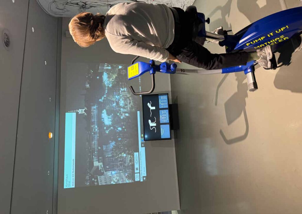Pump it Up!, Kunsthaus Graz, 2024. Visitor on the stationary bike
