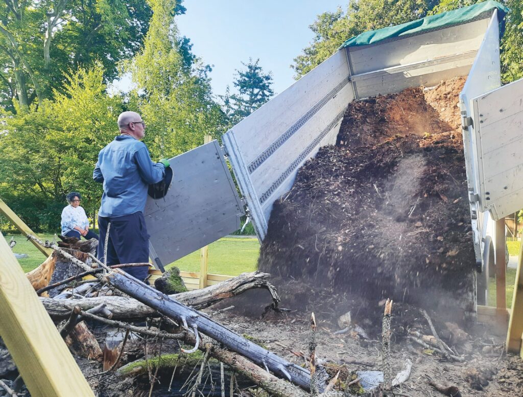 Forest material being unloaded from a truck in the garden